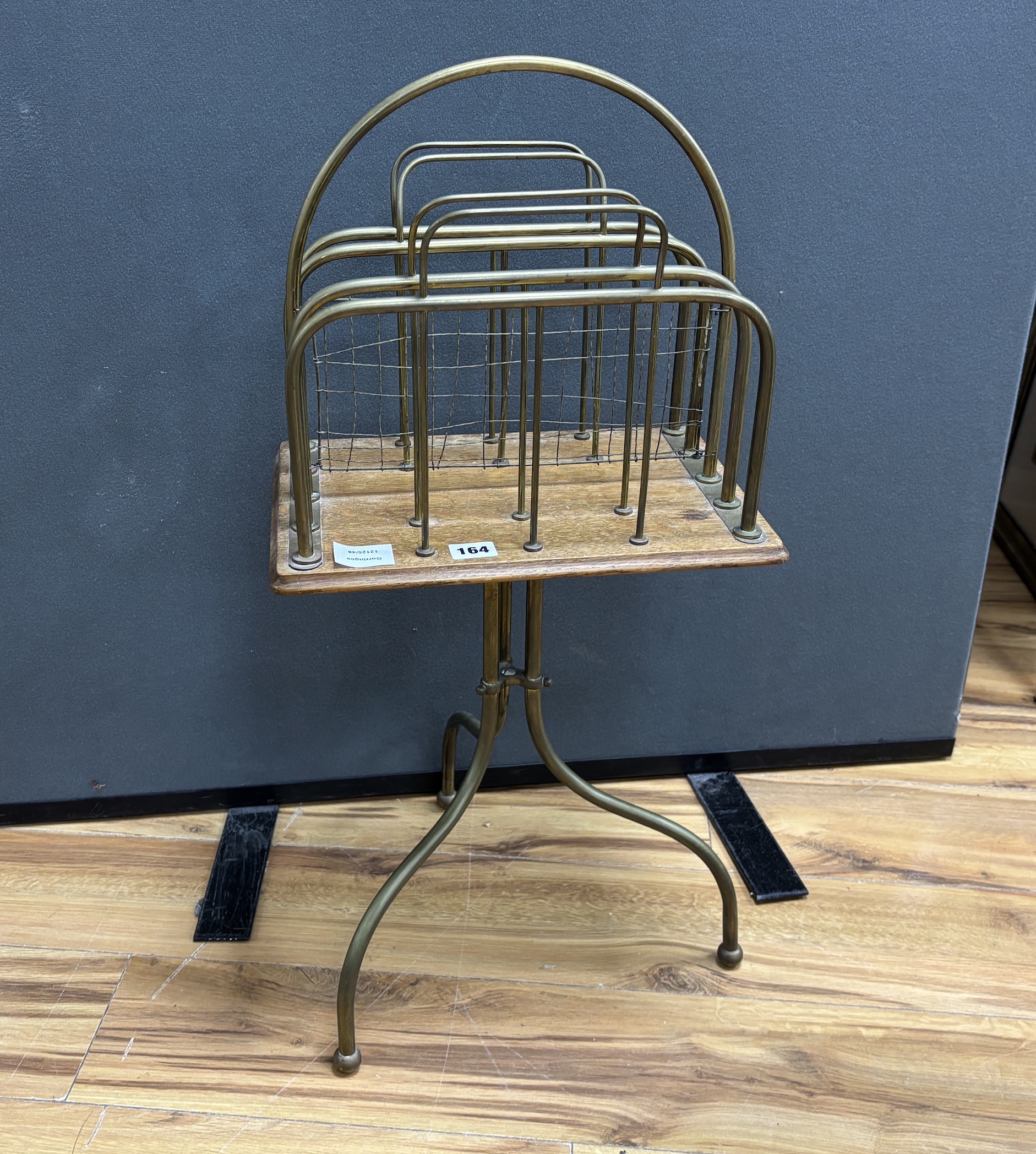 An early 20th century oak and tubular brass four division newspaper stand, height 74cm